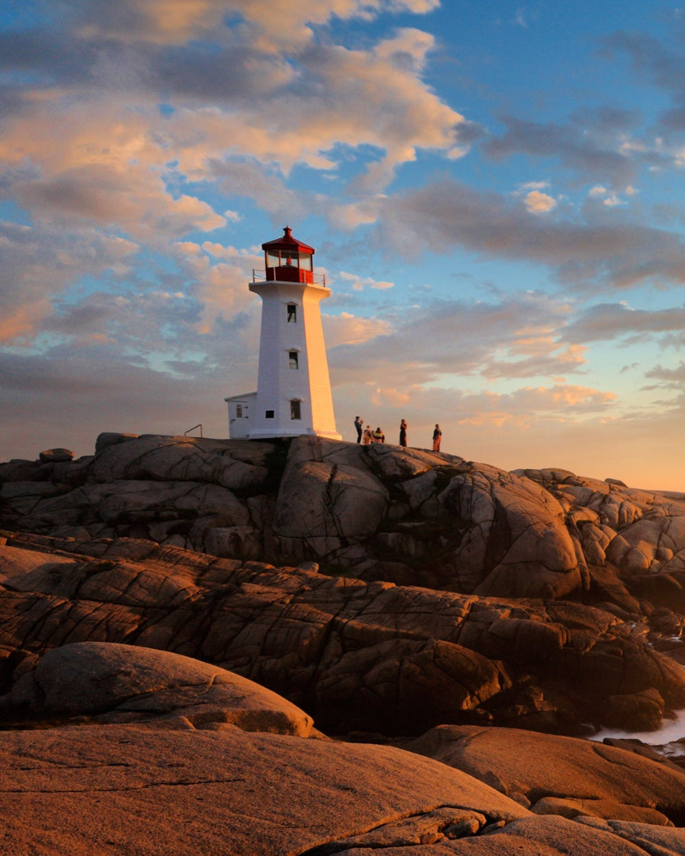 Lighthouse in Nova Scotia with sunset sky