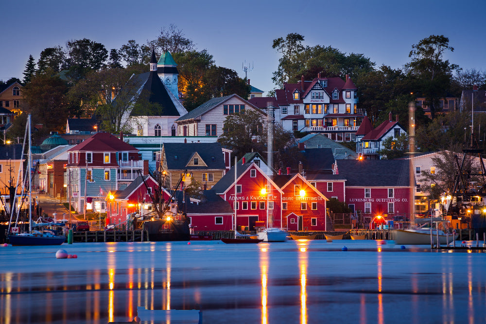 Dusk view of a quaint harbor with colorful buildings and boats. In Nova Scotia, Canada.
